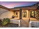 A stylish home featuring a covered patio with outdoor seating, stone accents, and a well-maintained front yard at 6551 E Flat Iron Loop, Gold Canyon, AZ 85118