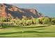 Scenic golf course featuring the iconic Superstition Mountain, offering a picturesque golfing experience at 6551 E Flat Iron Loop, Gold Canyon, AZ 85118