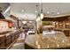 Open-concept kitchen with large island, granite countertops, stainless steel appliances, and pool view at 6551 E Flat Iron Loop, Gold Canyon, AZ 85118