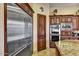 Spacious kitchen with stainless steel refrigerator, double ovens, custom cabinets, and granite countertops at 6551 E Flat Iron Loop, Gold Canyon, AZ 85118