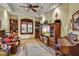 Cozy living room with coffered ceilings, built-in bookcases, shuttered windows, and natural light at 6551 E Flat Iron Loop, Gold Canyon, AZ 85118