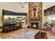 Spacious living room with rock fireplace, scenic views, and plush seating at 6551 E Flat Iron Loop, Gold Canyon, AZ 85118