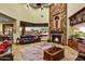 Grand living room with fireplace, desert views, and comfortable furniture at 6551 E Flat Iron Loop, Gold Canyon, AZ 85118