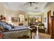 Sun-filled main bedroom with a seating area, tray ceiling, and arched doorway to the bathroom at 6551 E Flat Iron Loop, Gold Canyon, AZ 85118