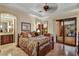 Bedroom with stone floors, en suite bathroom, and patio access offering views of the desert landscape at 6551 E Flat Iron Loop, Gold Canyon, AZ 85118