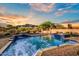 Beautiful pool and spa with mountain views, lush desert vegetation and colorful sunset at 6551 E Flat Iron Loop, Gold Canyon, AZ 85118