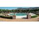 Relax by the pristine community pool surrounded by lush landscaping and scenic mountain views at 6551 E Flat Iron Loop, Gold Canyon, AZ 85118