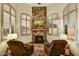 Cozy sitting room with a stone fireplace, comfortable chairs, and natural lighting at 6551 E Flat Iron Loop, Gold Canyon, AZ 85118