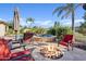 Luxurious backyard featuring a fire pit, pool, and relaxing lounge area at 6706 S Jacqueline Way, Gilbert, AZ 85298