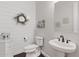 Elegant powder room with board and batten accent wall and white fixtures at 6706 S Jacqueline Way, Gilbert, AZ 85298