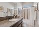 Well-lit bathroom with granite counters, decorative mirror, and a shower/tub combo at 6706 S Jacqueline Way, Gilbert, AZ 85298