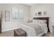 Bright bedroom with plantation shutters and light gray wood flooring at 6706 S Jacqueline Way, Gilbert, AZ 85298