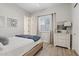 Comfortable bedroom with light wood floors and a sunny window at 6706 S Jacqueline Way, Gilbert, AZ 85298