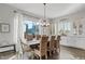 Dining area featuring a large window, wood table, and cabinetry for elegant entertaining at 6706 S Jacqueline Way, Gilbert, AZ 85298