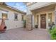 Inviting entryway with a stone pillar, wooden door and string lights at 6706 S Jacqueline Way, Gilbert, AZ 85298