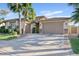 Attractive home exterior showcasing a three-car garage, lush landscaping, and inviting curb appeal at 6706 S Jacqueline Way, Gilbert, AZ 85298