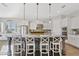 Bright kitchen with gray island, granite countertops, white cabinets, and pendant lighting at 6706 S Jacqueline Way, Gilbert, AZ 85298