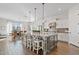 Open kitchen featuring an island with granite countertops, wooden flooring, and a dining area at 6706 S Jacqueline Way, Gilbert, AZ 85298