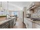 Modern kitchen flows into a dining area with an island, granite counters, and stainless steel appliances at 6706 S Jacqueline Way, Gilbert, AZ 85298