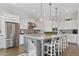 Open kitchen layout features an island with granite countertops and seating, and stainless steel appliances at 6706 S Jacqueline Way, Gilbert, AZ 85298