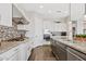 Stylish kitchen featuring granite countertops, mosaic backsplash, stainless steel appliances, and ample cabinet space at 6706 S Jacqueline Way, Gilbert, AZ 85298