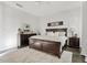 This primary bedroom features a dark wood bedframe, dresser and nightstands with grey rug, and plantation shutters at 6706 S Jacqueline Way, Gilbert, AZ 85298