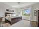Spacious primary bedroom with nice backyard views, ceiling fan, and dark wood furniture at 6706 S Jacqueline Way, Gilbert, AZ 85298