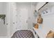 Inviting mud room with white bench, hooks, and patterned rug at 6706 S Jacqueline Way, Gilbert, AZ 85298