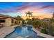 Stunning pool area showcasing a spa and mature landscaping, highlighted by a colorful sunset sky at 6706 S Jacqueline Way, Gilbert, AZ 85298