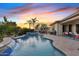 Resort-style pool and spa with waterfall feature, surrounded by lush tropical landscaping, perfect for outdoor living at 6706 S Jacqueline Way, Gilbert, AZ 85298