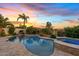 Inviting pool and spa with a waterfall feature, set against a picturesque desert landscape at twilight at 6706 S Jacqueline Way, Gilbert, AZ 85298