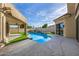Lush backyard with a pool, hot tub, artificial turf, and outdoor patio perfect for entertaining and relaxing at 7439 E Beryl Ave, Scottsdale, AZ 85258