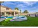 Spacious backyard featuring a pool, hot tub, and manicured artificial turf, ideal for outdoor living at 7439 E Beryl Ave, Scottsdale, AZ 85258