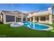 Beautiful backyard showcasing a swimming pool, hot tub, and well-maintained artificial grass at 7439 E Beryl Ave, Scottsdale, AZ 85258