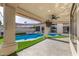 Covered patio with a ceiling fan overlooks the pool and spa, offering a perfect outdoor relaxation and entertainment space at 7439 E Beryl Ave, Scottsdale, AZ 85258