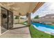 Covered patio with a ceiling fan, overlooking the pool, spa, and artificial turf, perfect for relaxation and entertainment at 7439 E Beryl Ave, Scottsdale, AZ 85258