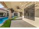 View of a covered patio with a ceiling fan and a pool with a spa, offering a perfect outdoor relaxation and entertainment space at 7439 E Beryl Ave, Scottsdale, AZ 85258
