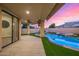 Inviting covered patio with seamless indoor-outdoor flow to the pool and spa, complete with ceiling fan and string lights at 7439 E Beryl Ave, Scottsdale, AZ 85258