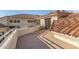 Expansive balcony with rooftop views and tiled roof overhang, casting shadows at 7439 E Beryl Ave, Scottsdale, AZ 85258