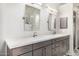 Bathroom featuring dual sinks with modern fixtures and a view into the shower area at 7439 E Beryl Ave, Scottsdale, AZ 85258