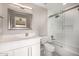 Modern bathroom with a white vanity, sleek mirror, and tiled shower and tub at 7439 E Beryl Ave, Scottsdale, AZ 85258
