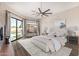 Bedroom with large windows and access to pool area with views of backyard at 7439 E Beryl Ave, Scottsdale, AZ 85258