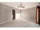 Spacious bedroom featuring a ceiling fan, carpet, and access to an ensuite bathroom at 7439 E Beryl Ave, Scottsdale, AZ 85258