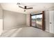 Comfortable bedroom with a ceiling fan, neutral colors, carpet, and sliding doors to the outside at 7439 E Beryl Ave, Scottsdale, AZ 85258