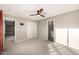 Bright bedroom with ceiling fan, carpet, access to the bathroom, and closet for storage at 7439 E Beryl Ave, Scottsdale, AZ 85258