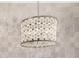 Close-up of decorative chandelier fixture with neutral tile background at 7439 E Beryl Ave, Scottsdale, AZ 85258