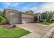 Charming home exterior featuring a three-car garage, lush lawn, and mature trees enhancing curb appeal at 7439 E Beryl Ave, Scottsdale, AZ 85258