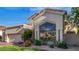 Exterior shot showing desert landscaping, the garage and a red tile roof at 7439 E Beryl Ave, Scottsdale, AZ 85258