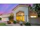 A close exterior shot with desert landscaping and flowers around the home's window at 7439 E Beryl Ave, Scottsdale, AZ 85258