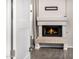 Cozy corner fireplace with a tile hearth and wood-burning insert at 7439 E Beryl Ave, Scottsdale, AZ 85258